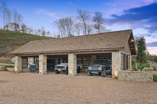 view of garage at dusk