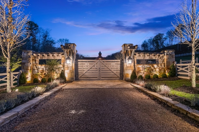 view of gate at dusk