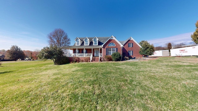 cape cod home with a front lawn and covered porch