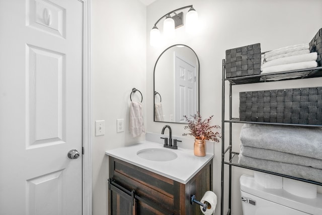 bathroom featuring vanity and toilet