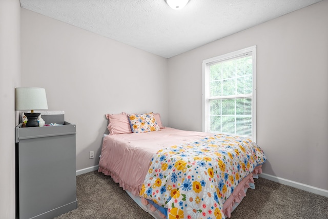 carpeted bedroom featuring a textured ceiling