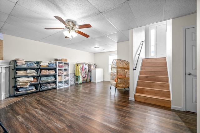 interior space with a paneled ceiling, dark hardwood / wood-style floors, and plenty of natural light