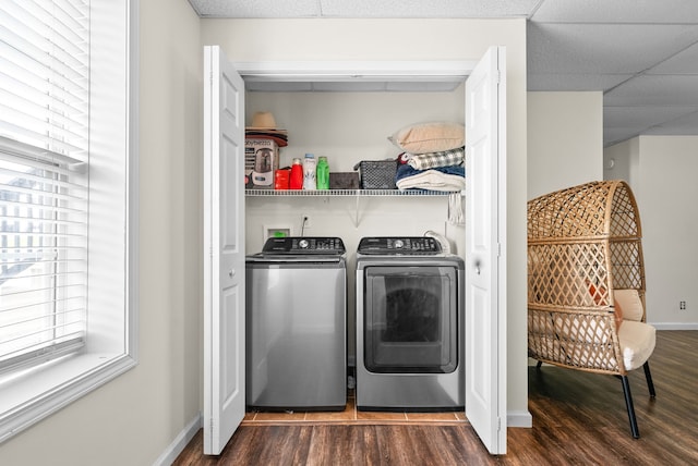 washroom featuring dark wood-type flooring and washing machine and clothes dryer