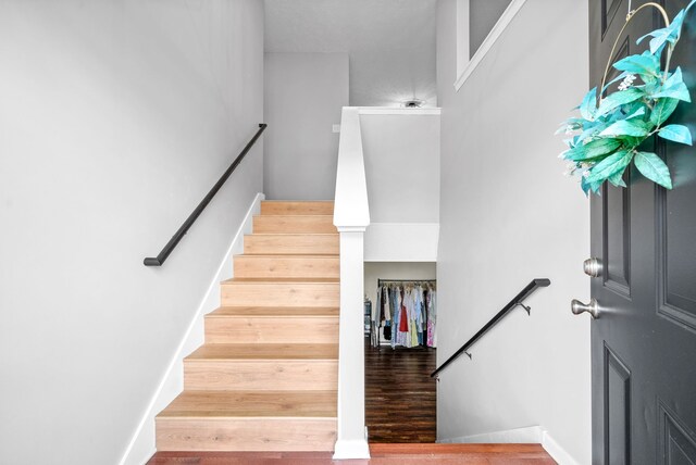 staircase featuring hardwood / wood-style floors