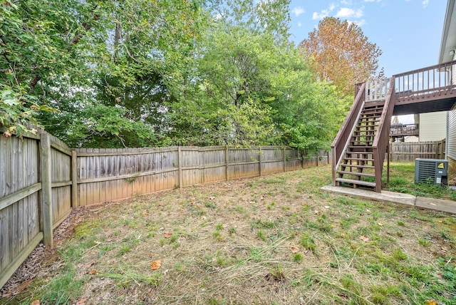 view of yard featuring a wooden deck and cooling unit