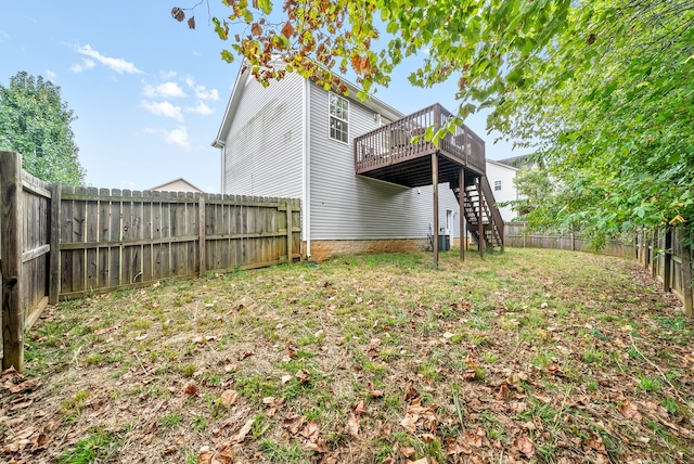 back of property with central AC and a deck