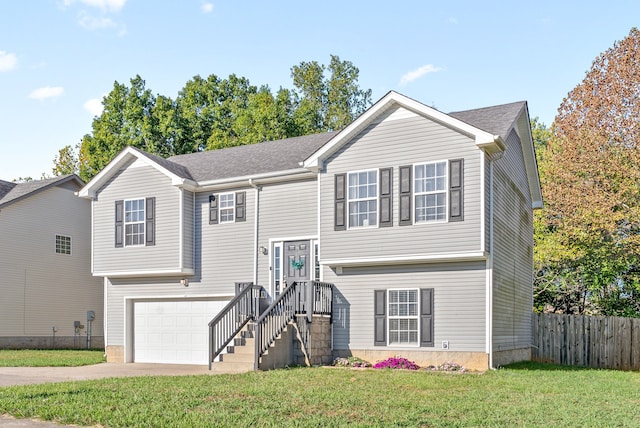 bi-level home featuring a garage and a front lawn