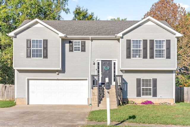 split foyer home with a front lawn and a garage