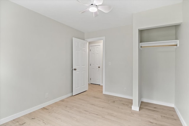 unfurnished bedroom with ceiling fan, light wood-type flooring, and a closet