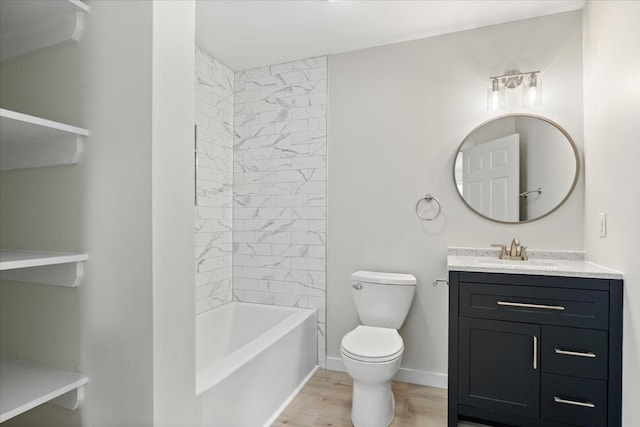 full bathroom featuring hardwood / wood-style floors, vanity, toilet, and tiled shower / bath combo