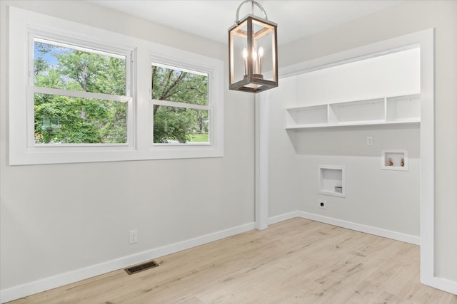 laundry room with a chandelier, washer hookup, light wood-type flooring, and hookup for an electric dryer