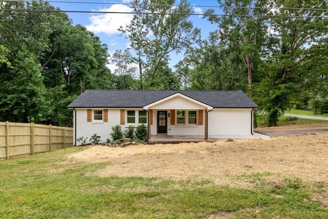 single story home featuring covered porch and a front lawn