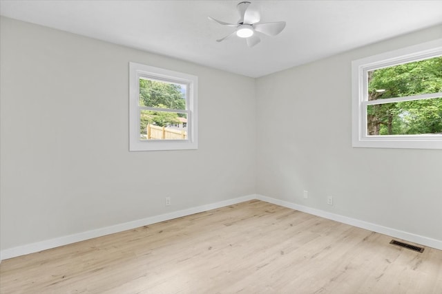 spare room featuring light hardwood / wood-style floors, plenty of natural light, and ceiling fan