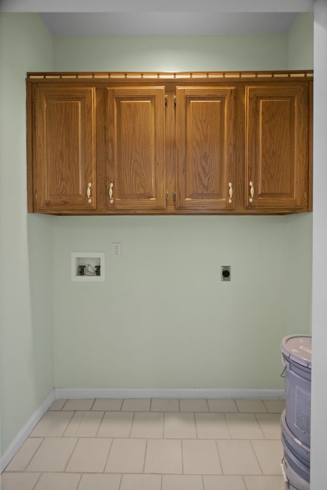 washroom featuring washer hookup, electric dryer hookup, light tile patterned flooring, and cabinets