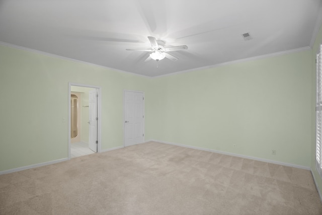 unfurnished bedroom featuring light carpet, crown molding, and ceiling fan