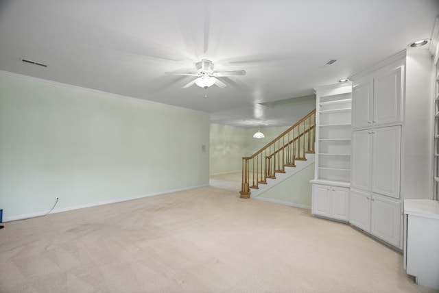 carpeted empty room with ceiling fan and ornamental molding