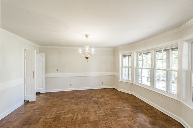 spare room featuring baseboards, a notable chandelier, and ornamental molding