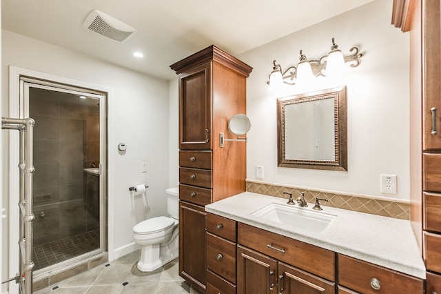 bathroom with visible vents, toilet, a shower stall, vanity, and tile patterned flooring