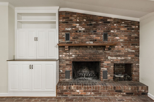 interior details featuring crown molding, a fireplace, and baseboards