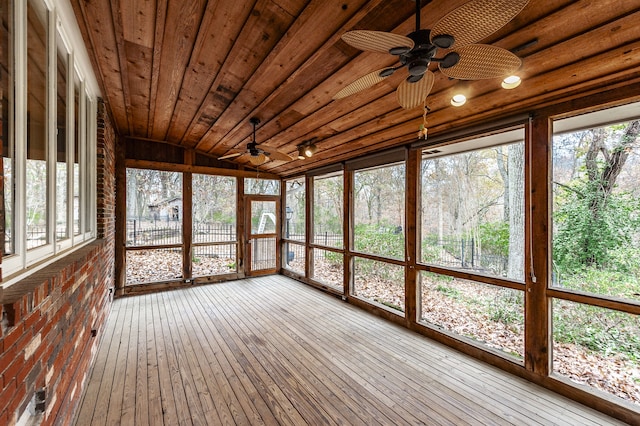 unfurnished sunroom featuring lofted ceiling, wood ceiling, and ceiling fan