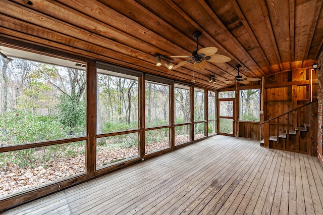 unfurnished sunroom featuring wooden ceiling and a ceiling fan