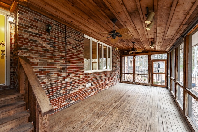 unfurnished sunroom with wood ceiling and a healthy amount of sunlight