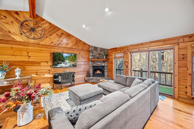 living room featuring vaulted ceiling with beams and wooden walls