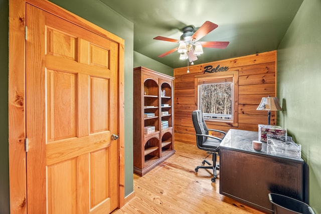 home office with light hardwood / wood-style floors and ceiling fan