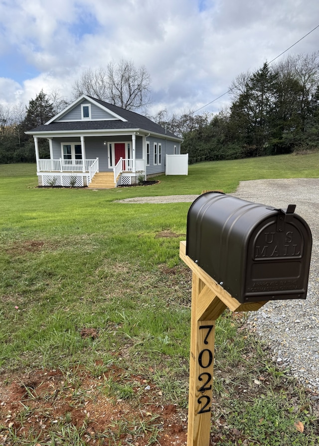 view of front of property with a front yard and covered porch