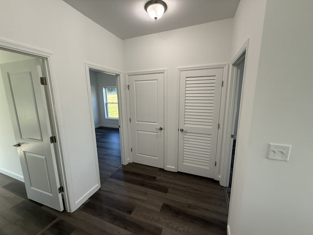 corridor with dark hardwood / wood-style floors