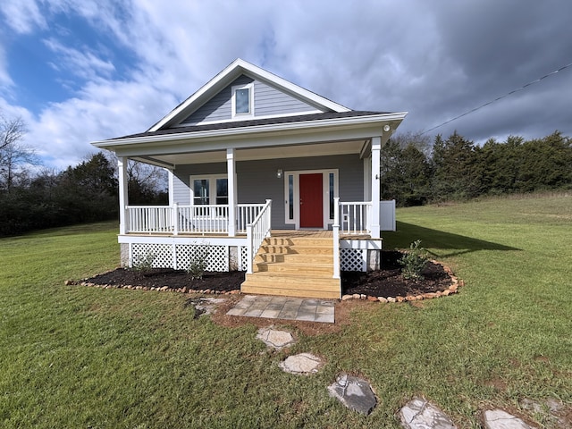 bungalow featuring covered porch and a front yard