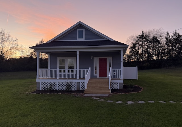 view of front facade with a yard and covered porch