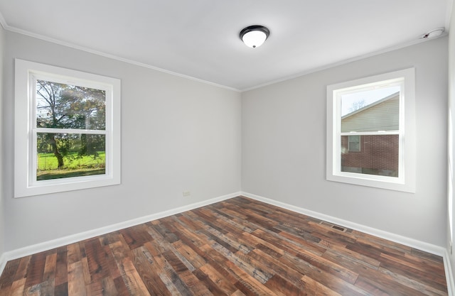 unfurnished room with ornamental molding and dark wood-type flooring