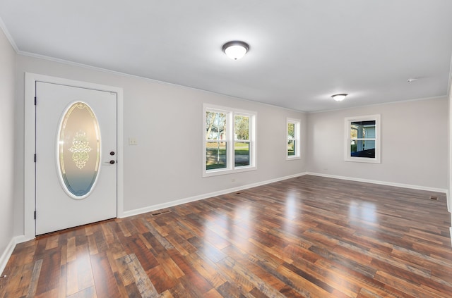 foyer featuring crown molding and dark wood-type flooring