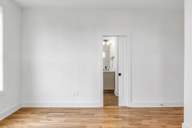 spare room featuring light hardwood / wood-style flooring and sink