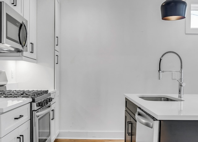 kitchen featuring light hardwood / wood-style floors, white cabinetry, sink, and appliances with stainless steel finishes