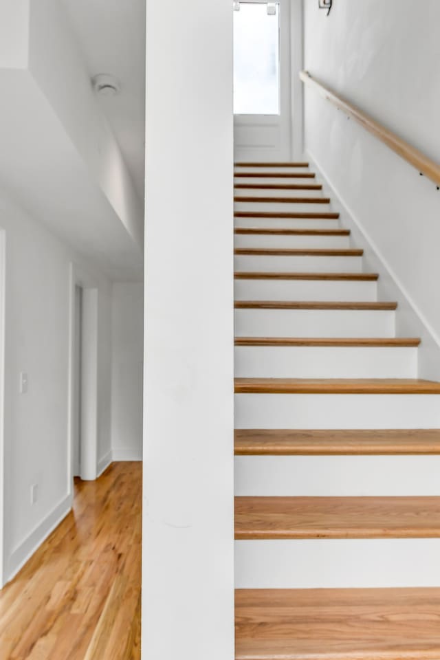 stairway featuring hardwood / wood-style floors