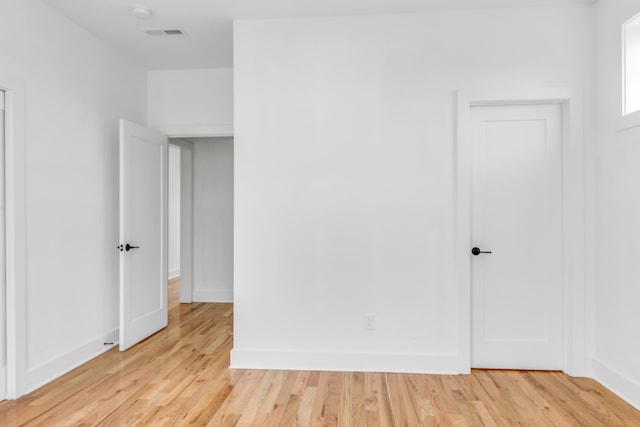 unfurnished room with light wood-type flooring