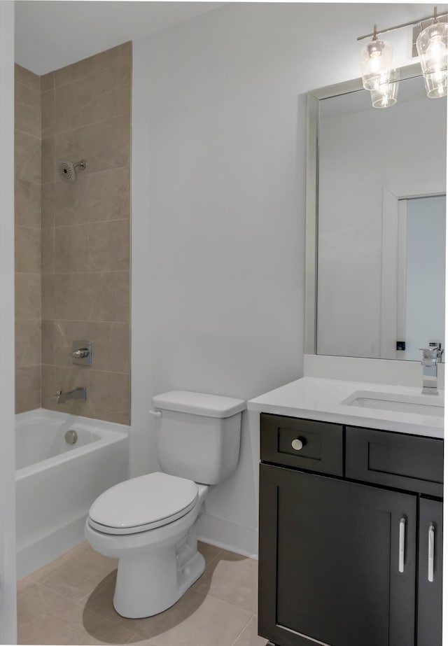 full bathroom featuring toilet, vanity, tiled shower / bath combo, and tile patterned floors