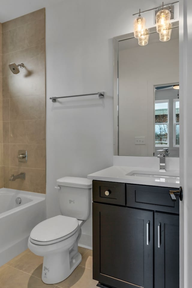 full bathroom with tile patterned floors, vanity, toilet, and tiled shower / bath combo