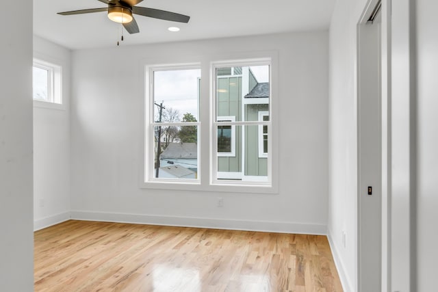 empty room featuring ceiling fan and light hardwood / wood-style floors