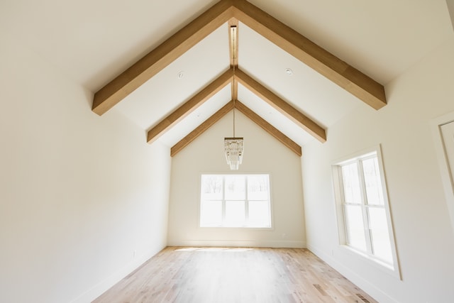 unfurnished living room with hardwood / wood-style floors, vaulted ceiling with beams, and an inviting chandelier