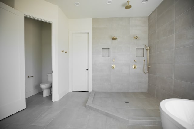 bathroom featuring tile patterned flooring, plus walk in shower, and toilet