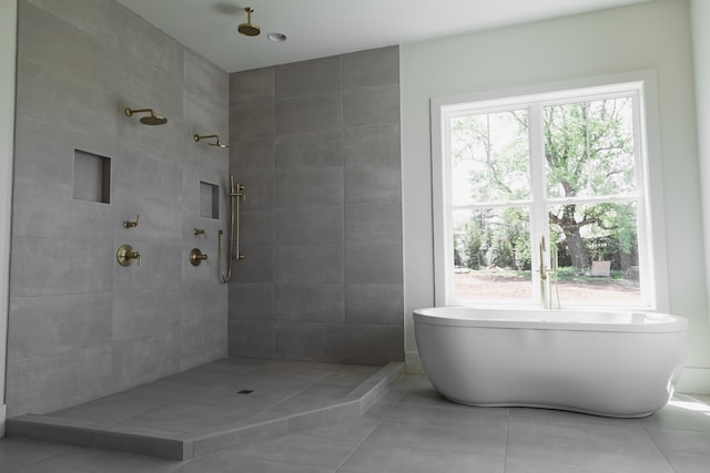 bathroom featuring tile patterned flooring and shower with separate bathtub