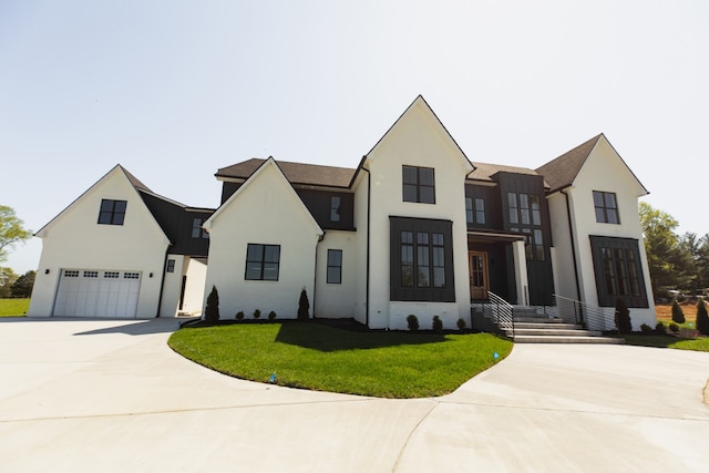 modern inspired farmhouse with a garage and a front lawn