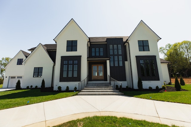 modern farmhouse style home with french doors and a front lawn