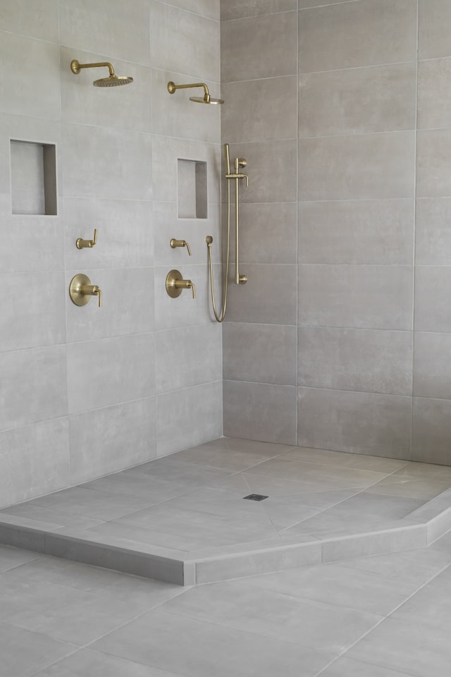 bathroom featuring tile patterned floors and tiled shower