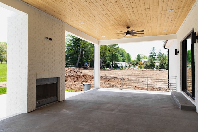 view of patio / terrace with ceiling fan and an outdoor brick fireplace