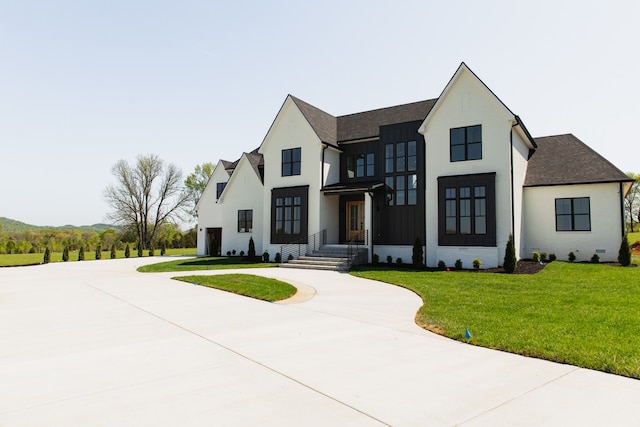 modern farmhouse with a front lawn