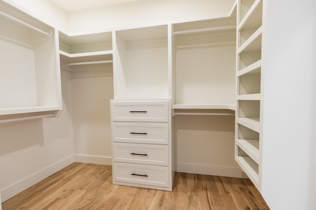 walk in closet with light wood-type flooring